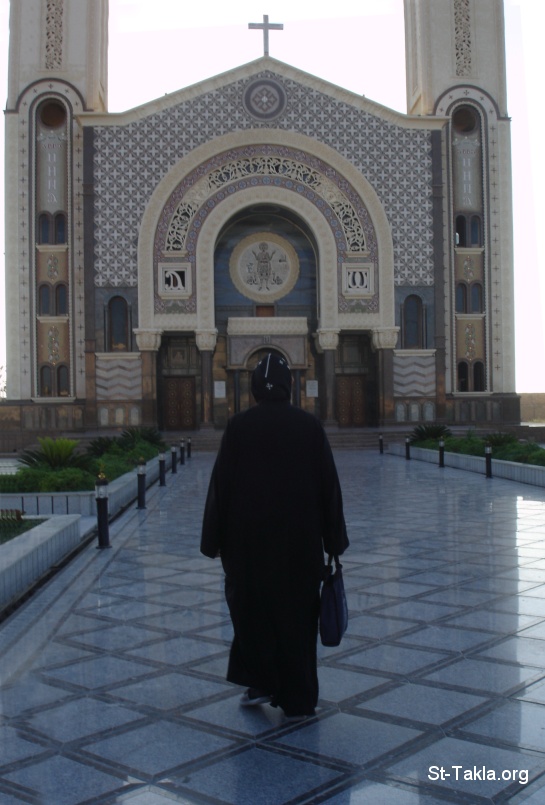St-Takla.org Image: Coptic Orthodox Monk going to Church, St. Mina Monastery Cathedral, Mariot, Egypt - Fr. Discoros Avva Mina - Photograph by Michael Ghaly for St-Takla.org     :          ء  -      -    :    
