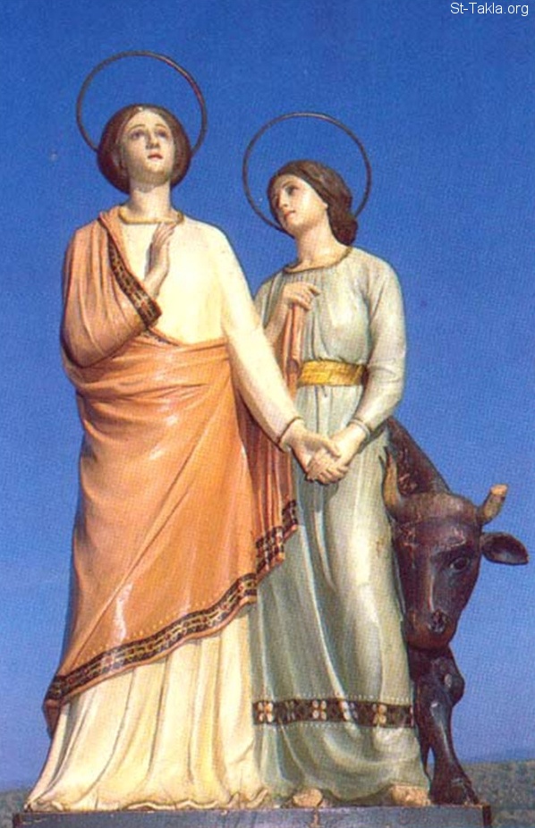 St-Takla.org Image: Statue showing Saint Perpetua looking up to the heavens, while hoding the hand of Saint Felicity, where we can see the wild cow behind Her     :           ӡ     